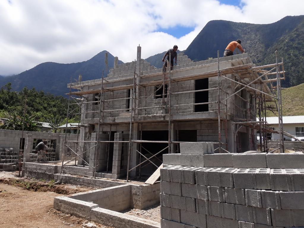 Maison individuelle moderne en cours de construction avec des artisans